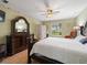 Well-lit main bedroom boasting light hardwood floors and a large decorative dresser at 8222 Haven Harbour Way, Bradenton, FL 34212