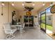Relaxing screened patio with white outdoor seating, ceiling fan and lighting at 8222 Haven Harbour Way, Bradenton, FL 34212