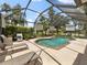 Inviting screened-in pool area perfect for outdoor relaxation and entertaining with seating at 8222 Haven Harbour Way, Bradenton, FL 34212