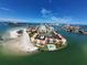 Panoramic aerial shot of a waterfront community featuring condos, a pool, and beach access at 855 Bayway Blvd # 908, Clearwater Beach, FL 33767
