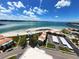 Aerial view of waterfront condos with beach, pool, lush landscaping, and convenient parking at 855 Bayway Blvd # 908, Clearwater Beach, FL 33767
