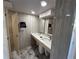 Bathroom with marble tile floor, large vanity, and two sinks, plus a beige door at 855 Bayway Blvd # 908, Clearwater Beach, FL 33767