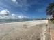 Beach on a sunny day with calm water and bridge in the background at 855 Bayway Blvd # 908, Clearwater Beach, FL 33767