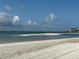 Sandy beach with a bridge and buildings in the distance at 855 Bayway Blvd # 908, Clearwater Beach, FL 33767