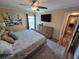 Comfortable bedroom boasting a spacious layout, neutral décor, and access to a private balcony with water views at 855 Bayway Blvd # 908, Clearwater Beach, FL 33767