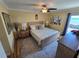 Cozy bedroom featuring neutral tones, a ceiling fan, and a sliding door to a private balcony at 855 Bayway Blvd # 908, Clearwater Beach, FL 33767