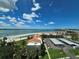 Scenic view showcasing beachfront condos with private parking, set against a backdrop of clear blue skies and ocean at 855 Bayway Blvd # 908, Clearwater Beach, FL 33767