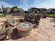 Outdoor firepit with Adirondack chairs and surrounding brick patio at 855 Bayway Blvd # 908, Clearwater Beach, FL 33767