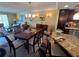 Open-concept floor plan with kitchen, dining and living areas featuring hardwood floors and comfortable seating at 855 Bayway Blvd # 908, Clearwater Beach, FL 33767