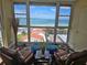 Inviting seating area with picturesque views through expansive windows showcasing the beautiful oceanfront scenery at 855 Bayway Blvd # 908, Clearwater Beach, FL 33767