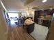 Open-concept kitchen, dining and living areas feature island seating, dark cabinetry, and wood flooring at 855 Bayway Blvd # 908, Clearwater Beach, FL 33767