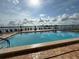 Community pool with lounge chairs and lake view at 855 Bayway Blvd # 908, Clearwater Beach, FL 33767