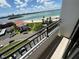 Balcony view showcasing sandy beaches, serene ocean waters, city buildings, and a bright cloudy sky at 855 Bayway Blvd # 908, Clearwater Beach, FL 33767
