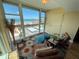 This relaxing sitting area includes comfy chairs, bright windows, and beautiful bay views at 855 Bayway Blvd # 908, Clearwater Beach, FL 33767