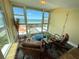 This relaxing sitting area includes comfy chairs, bright windows, and beautiful bay views at 855 Bayway Blvd # 908, Clearwater Beach, FL 33767