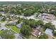 An aerial view of a residential neighborhood with tree lined streets and local businesses nearby at 878 Franklin Cir, Palm Harbor, FL 34683