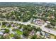 A high angle shot showing the placement of homes relative to the streets, local retail and more greenery at 878 Franklin Cir, Palm Harbor, FL 34683