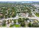 A scenic aerial view that captures homes with close proximity to roads, retail, and green spaces at 878 Franklin Cir, Palm Harbor, FL 34683