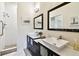 Well-lit bathroom featuring dual vanities, modern fixtures, and tile floors at 878 Franklin Cir, Palm Harbor, FL 34683