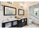 Well-lit bathroom featuring dual vanities, modern fixtures, and tile floors at 878 Franklin Cir, Palm Harbor, FL 34683