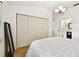 Bright bedroom featuring wood floors, a large window, and a comfortable bed with neutral decor at 878 Franklin Cir, Palm Harbor, FL 34683
