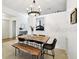Open dining space with modern chandelier and live-edge table with seating for six at 878 Franklin Cir, Palm Harbor, FL 34683