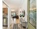 Entryway with tile floor, decoratively framed glass entry door, and view into kitchen and living room at 878 Franklin Cir, Palm Harbor, FL 34683