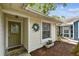 Lovely home featuring a welcoming front entrance, a wreath, and neatly trimmed landscaping at 878 Franklin Cir, Palm Harbor, FL 34683