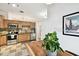 Bright kitchen with stainless steel appliances, light wood cabinetry and tile flooring at 878 Franklin Cir, Palm Harbor, FL 34683