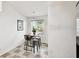 Kitchen eating area featuring a table, chairs, tiled floor and an outside view at 878 Franklin Cir, Palm Harbor, FL 34683