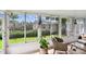 Enclosed sunroom featuring natural light and cozy seating, creating a perfect space for relaxation and leisure at 878 Franklin Cir, Palm Harbor, FL 34683