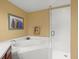 Bathroom featuring a bathtub, separate shower, and neutral wall art at 897 Lantern Way, Clearwater, FL 33765