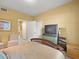 Bedroom featuring an entertainment center, mirrored dresser, and two closets at 897 Lantern Way, Clearwater, FL 33765
