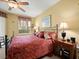 Comfortable bedroom featuring a ceiling fan, large window with natural light, and a decorative wrought iron bed frame at 897 Lantern Way, Clearwater, FL 33765