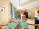 A breakfast nook leading to living spaces featuring a glass top table and wicker chairs at 897 Lantern Way, Clearwater, FL 33765