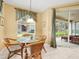 Breakfast nook featuring a glass table and chairs next to sliding glass doors at 897 Lantern Way, Clearwater, FL 33765