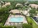 Aerial view of the community pool with lounge chairs, tables, and landscaping at 897 Lantern Way, Clearwater, FL 33765