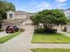 Charming townhouse featuring a private garage, lush landscaping, and a welcoming facade at 897 Lantern Way, Clearwater, FL 33765