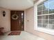 Welcoming front porch with a decorative wreath, a stylish door, and a large window at 897 Lantern Way, Clearwater, FL 33765