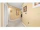 Bright hallway featuring neutral paint, white trim, and convenient closet space at 897 Lantern Way, Clearwater, FL 33765