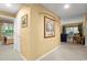 Bright hallway with neutral paint, artwork, and seamless access to other rooms at 897 Lantern Way, Clearwater, FL 33765