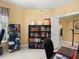 Bright home office features a collection of books on the shelves and artwork on the walls at 897 Lantern Way, Clearwater, FL 33765