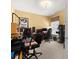 This home office features an open layout, natural light, and functional furniture for an ideal work environment at 897 Lantern Way, Clearwater, FL 33765