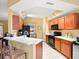 Bright kitchen features white countertops, modern appliances, tile flooring, and bar seating at 897 Lantern Way, Clearwater, FL 33765