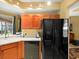 A kitchen featuring wooden cabinets and a black refrigerator at 897 Lantern Way, Clearwater, FL 33765