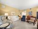 Inviting living room featuring neutral carpet, comfortable seating, and natural light at 897 Lantern Way, Clearwater, FL 33765