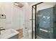 Modern bathroom featuring a tiled shower, gray vanity, white walls, and a sleek design at 905 N Willow Ave, Tampa, FL 33606