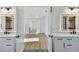 Bright bathroom with dual vanities and a view into the hallway, adding convenience and style to the space at 905 N Willow Ave, Tampa, FL 33606