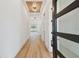 Inviting entryway featuring wood-look floors, a modern light fixture, and an open view to the living spaces at 905 N Willow Ave, Tampa, FL 33606