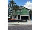Exterior view of a new home build with tropical landscaping and in the process of being completed at 905 N Willow Ave, Tampa, FL 33606